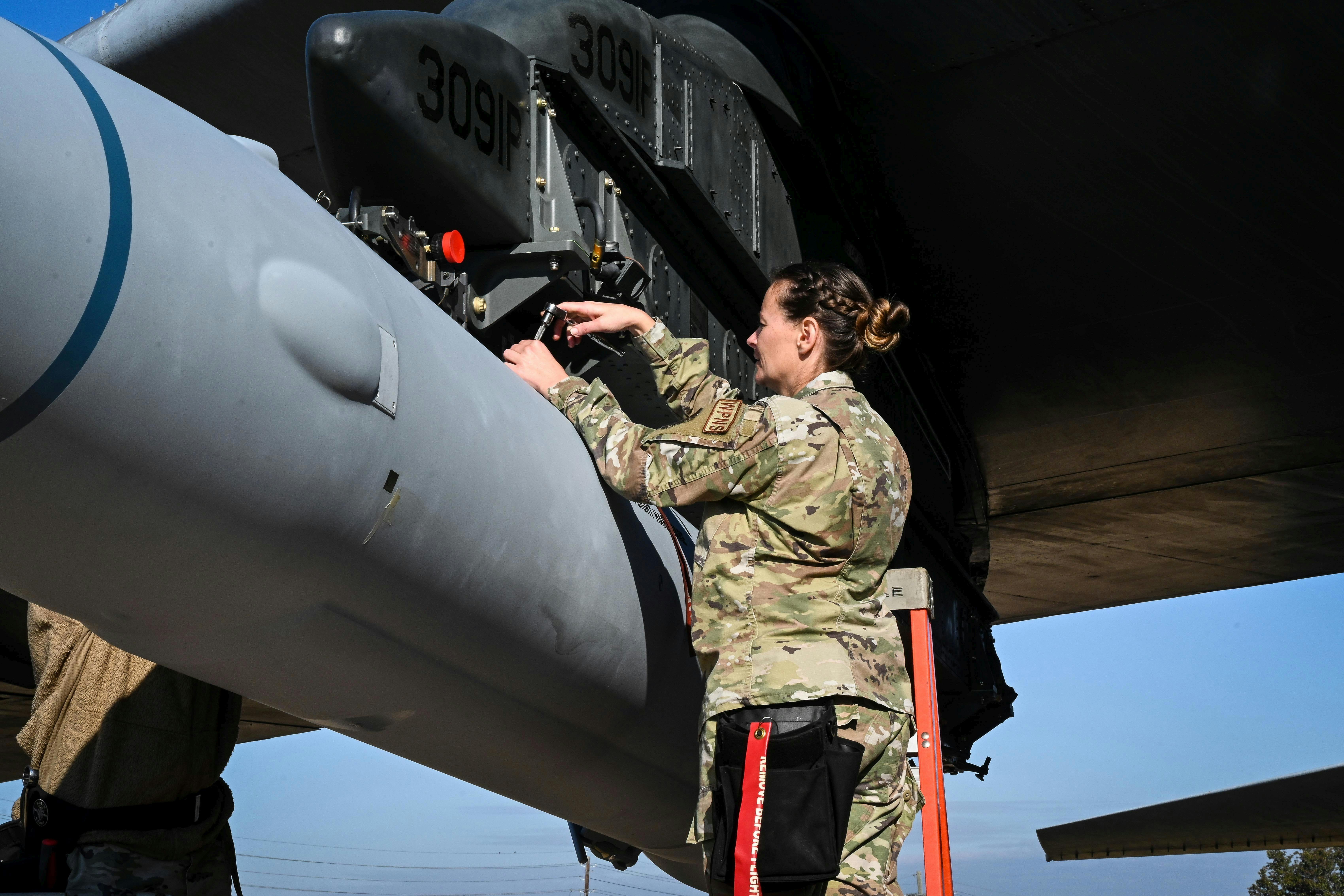 A U.S. Air Force loading standardization crew chief tightens bolts to secure the weapon to a B-52H bomber at Barksdale Air Force Base, La., in 2022 to validate the loading procedures for the Air Force's first hypersonic weapon. Air Force photo.