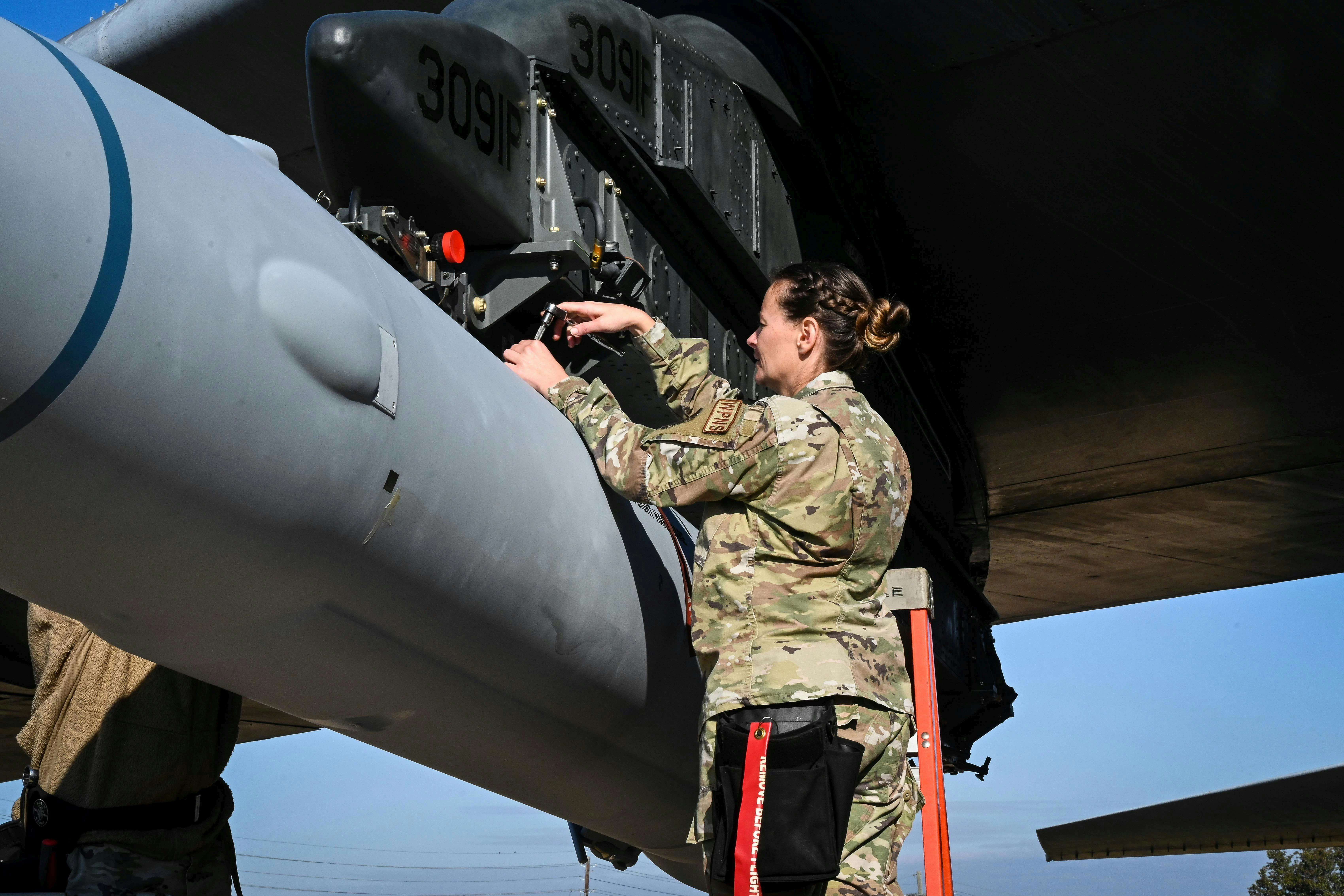 A U.S. Air Force loading standardization crew chief tightens bolts to secure the weapon to a B-52H bomber at Barksdale Air Force Base, La., in 2022 to validate the loading procedures for the Air Force's first hypersonic weapon. Air Force photo.