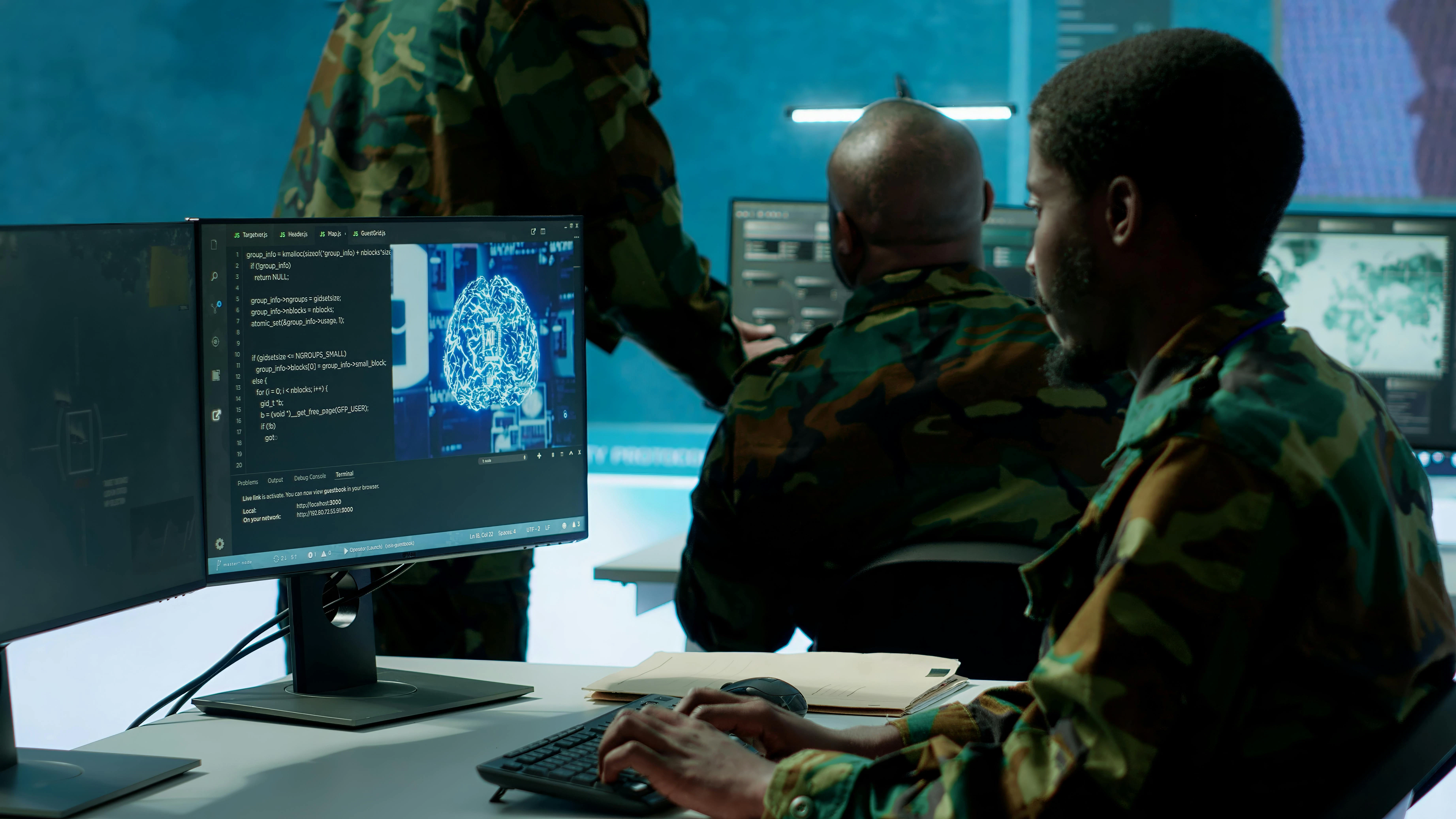 Programming engineer soldier handles AI brain and deep learning data on computer in command post, coordinates national defense operations.