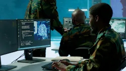 Programming engineer soldier handles AI brain and deep learning data on computer in command post, coordinates national defense operations.