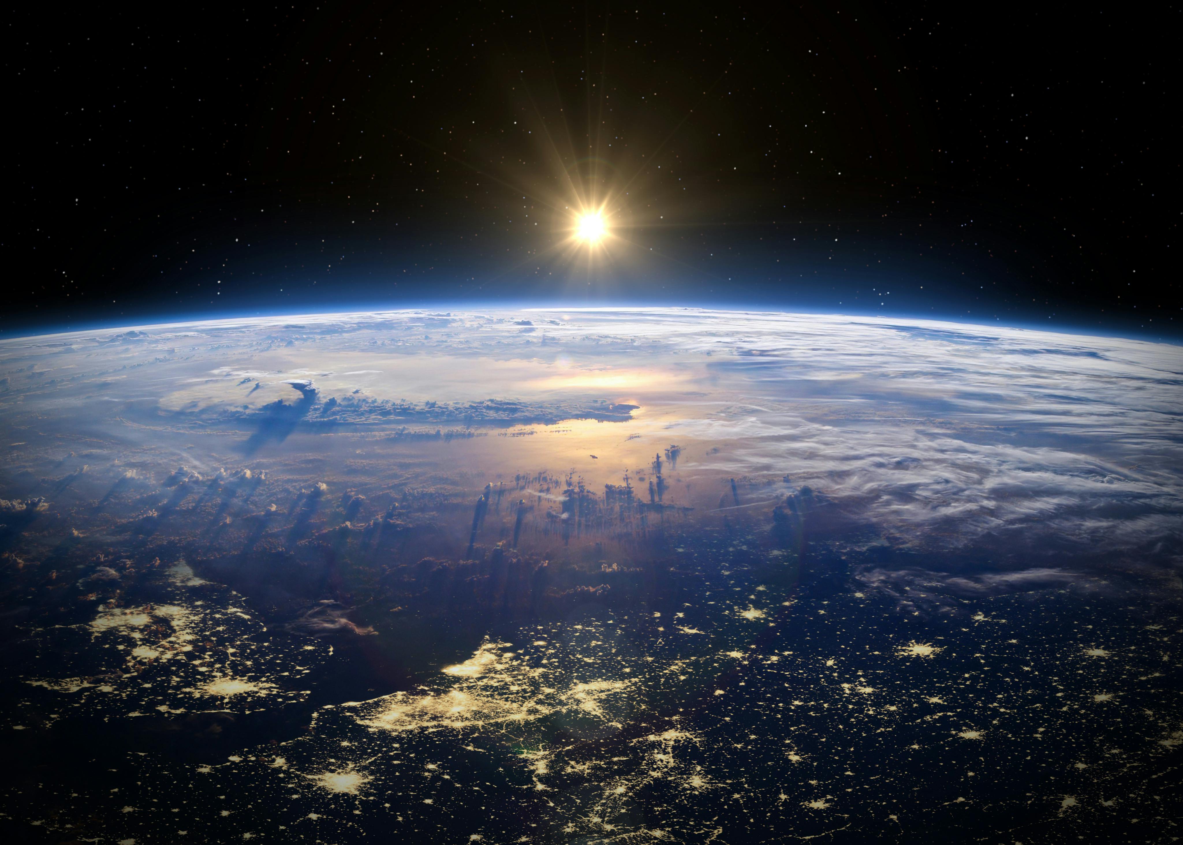 A view of Europe at night from space with the sun shining on the other side of the earth.