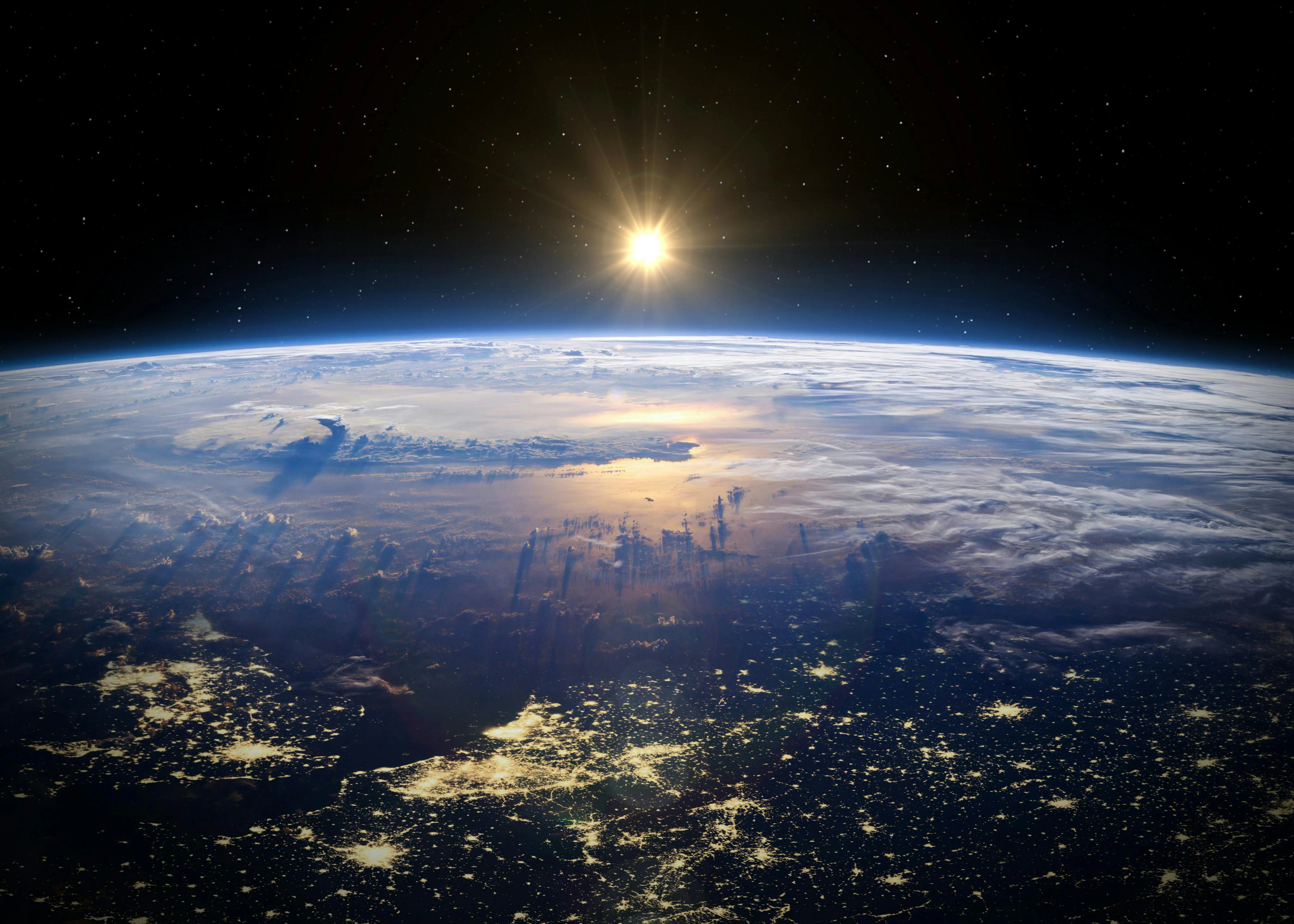 A view of Europe at night from space with the sun shining on the other side of the earth.