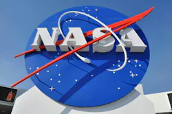 A sign with NASA's logo outside a building. A sign with NASA's logo outside a building.