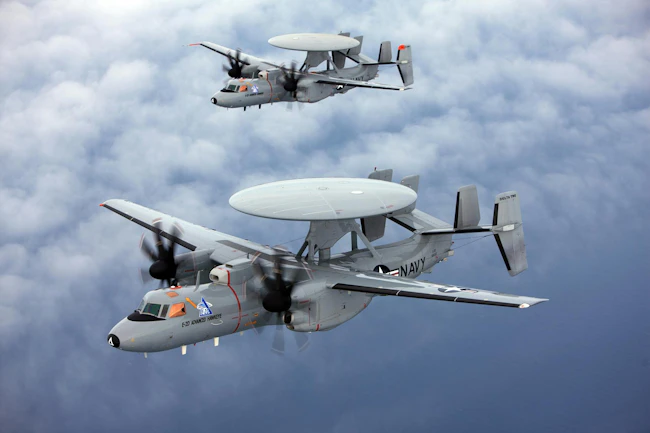Two Navy E-2D aircraft fly in tandem