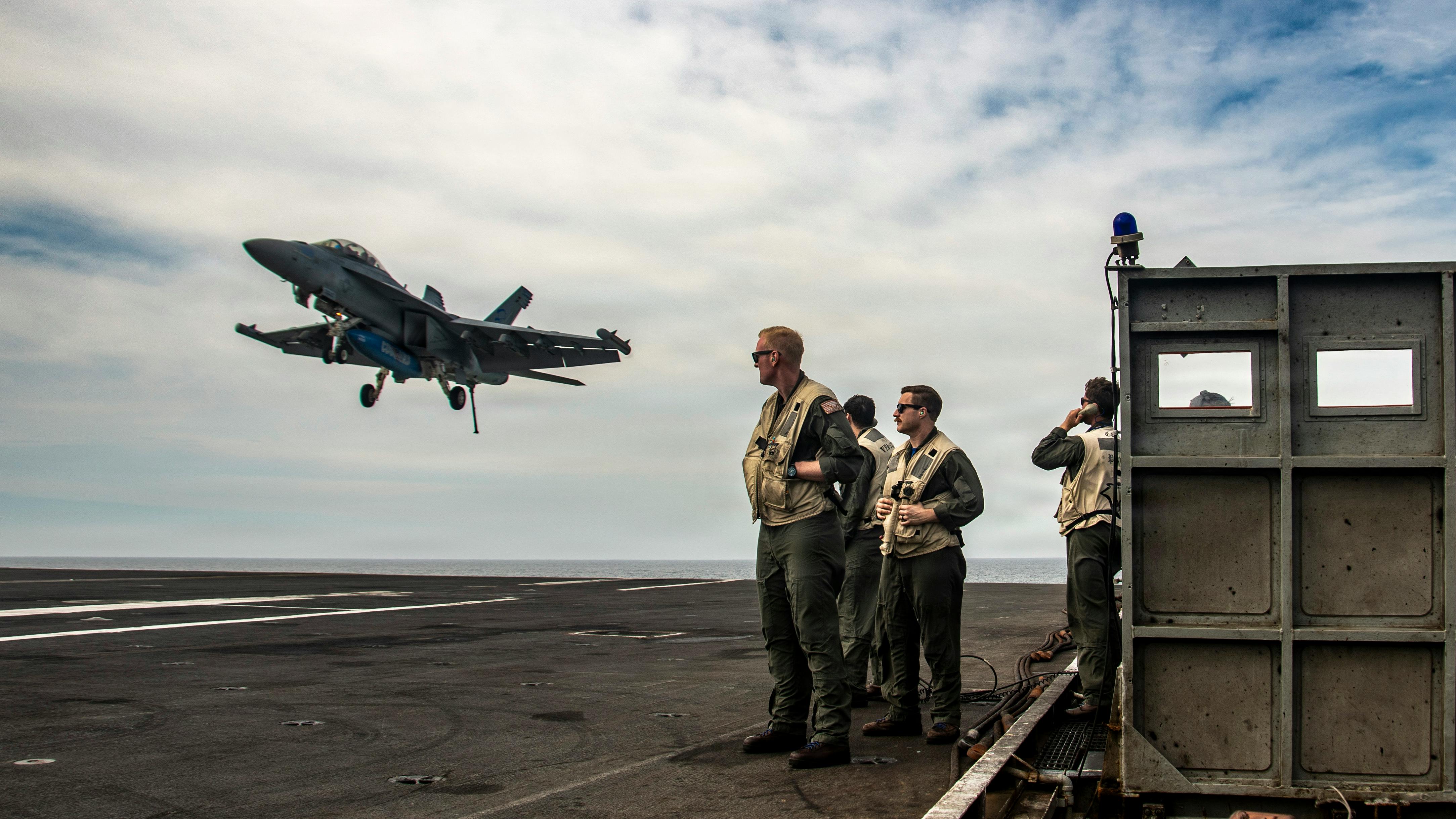 U.S. Navy Landing Signal Officers guide an E/A-18G Growler, attached to the &ldquo;Cougars&rdquo; of Electronic Attack Squadron (VAQ) 139, for an arrested landing on the flight deck of Nimitz-class aircraft carrier USS Nimitz (CVN 68) in the Pacific Ocean in April 2026. U.S. Navy photo by Mass Communication Specialist 2nd Class Jaron Wills.