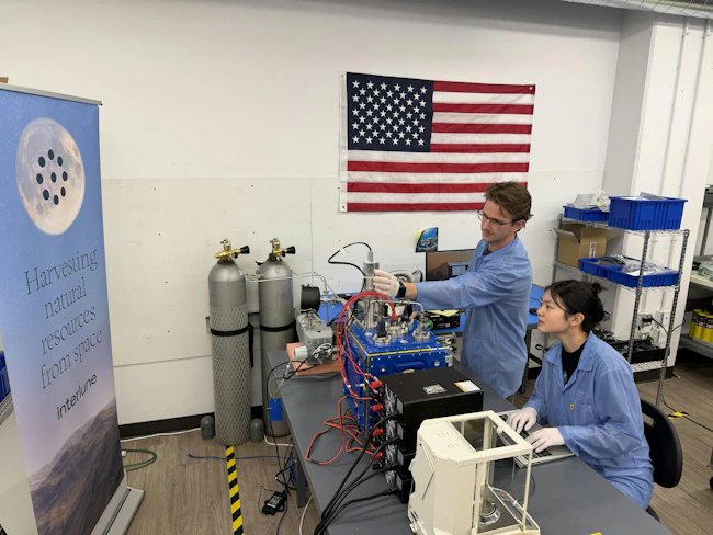 Interlune test engineer Alex Lewandowski (left) and mechanical engineer Jessica Wu (right) check test equipment for the mass spectrometer system in the Regolith Lab at the company&rsquo;s Seattle headquarters. Interlune photo.
