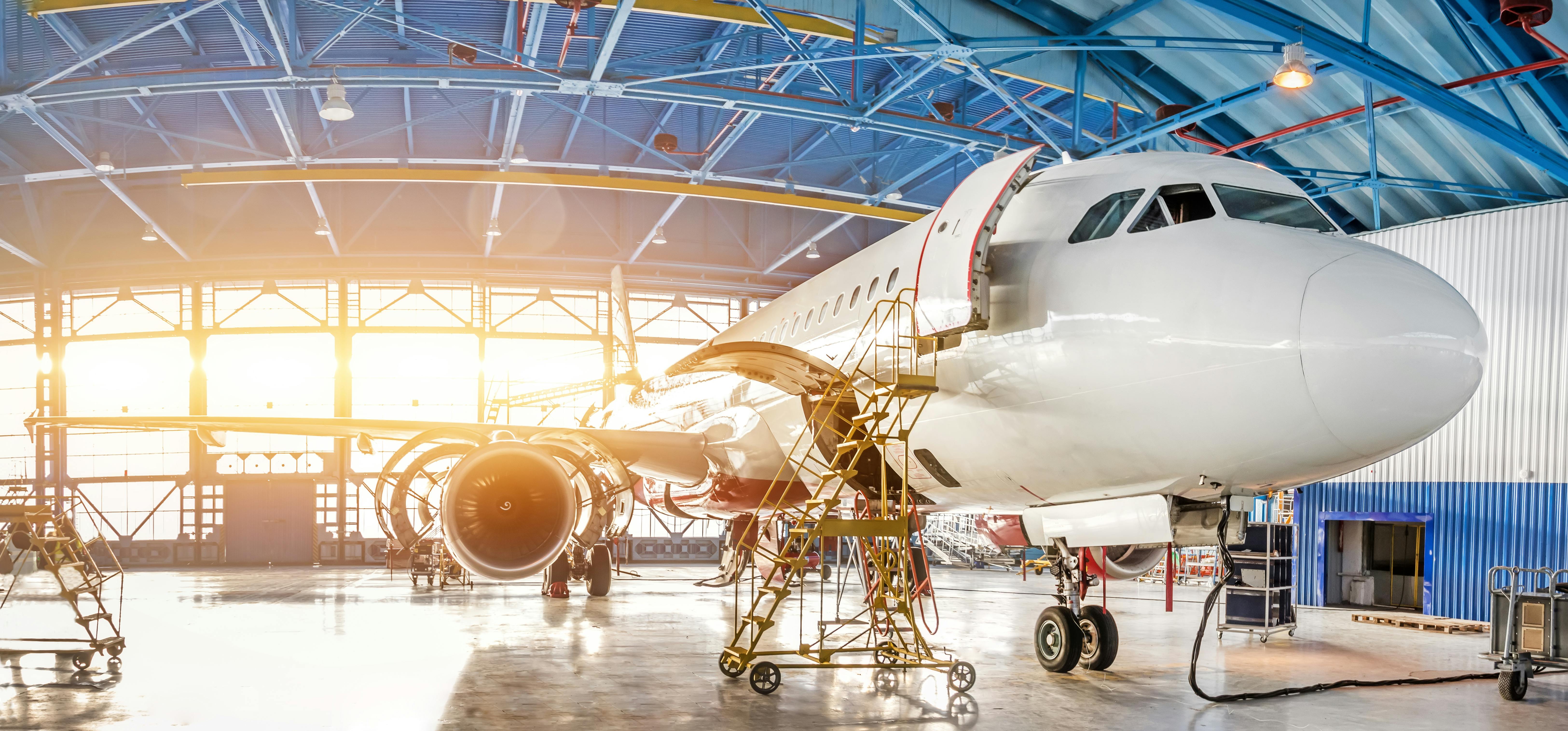 A commercial aircraft is in a hangar being updated
