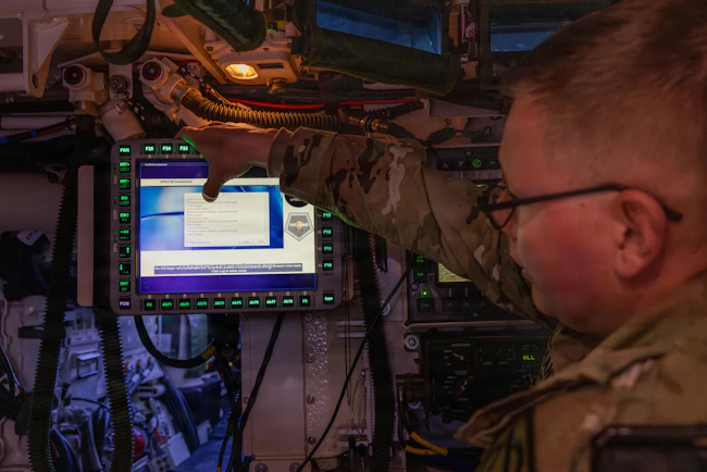 Lt. Col. David Hanna, Product Manager for Application Nexus for Key Resources (PdM ANKR) assigned to Capability Program Executive Command, Control, Communications, and Network (CPE C3N), demonstrates Spectre&rsquo;s embedded training system on a Stryker during exercise Ivy Sting 4 at Fort Carson, Colo. U.S. Army photo by Spc. Jonathan Reyes.