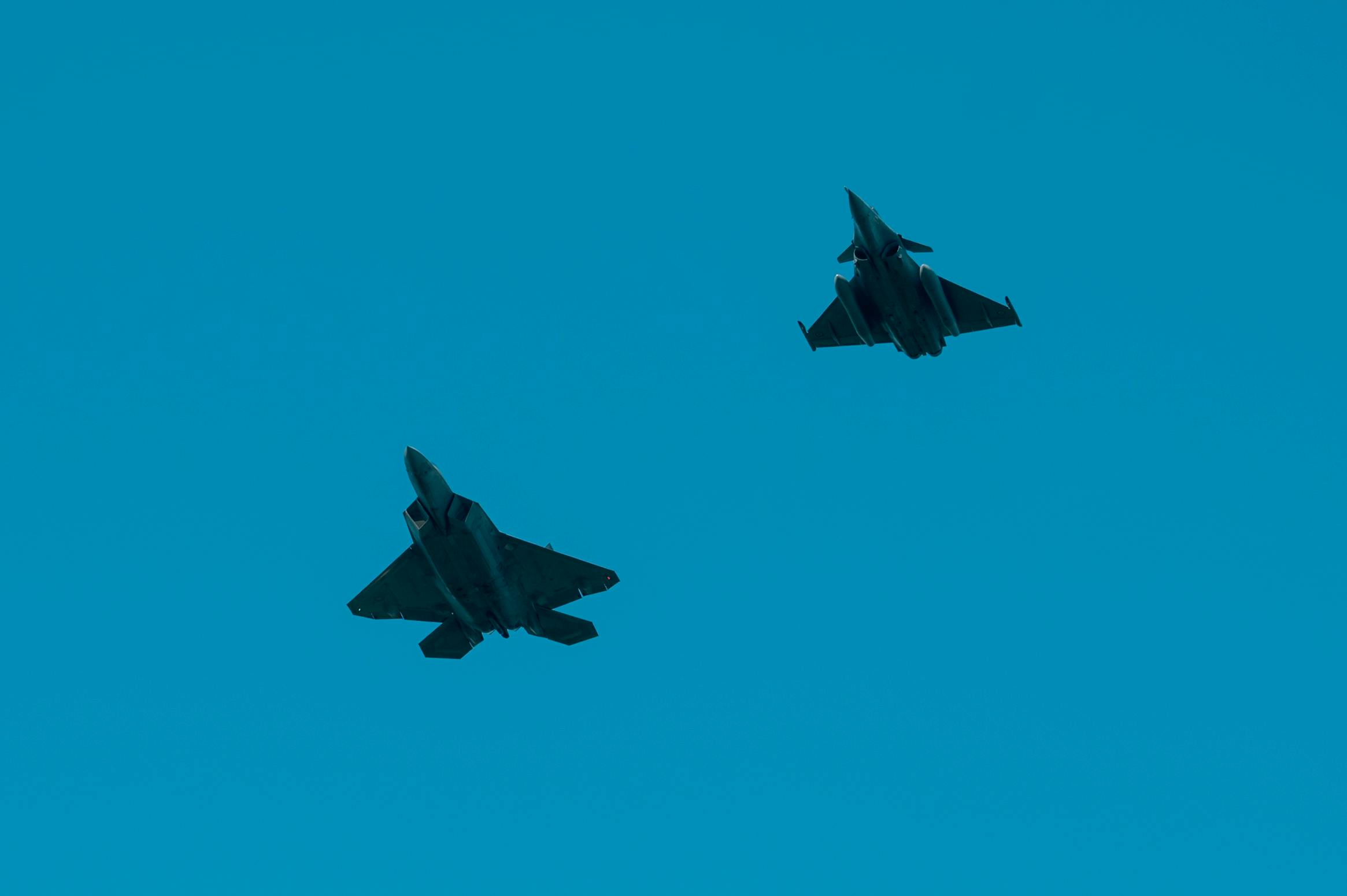 An F-22 Raptor and a French Air Force Dassault Rafale multi-role fighter perform a flyover during the Yorktown day parade at the Yorktown Battlefield, Va. The French Air Force and the U.S. Air Force flying side by side reflected the way the French fought alongside the U.S. during the siege of Yorktown, securing a victory that paved the way for America and freedom. US Air Force photo by Senior Airman Ian Sullens.