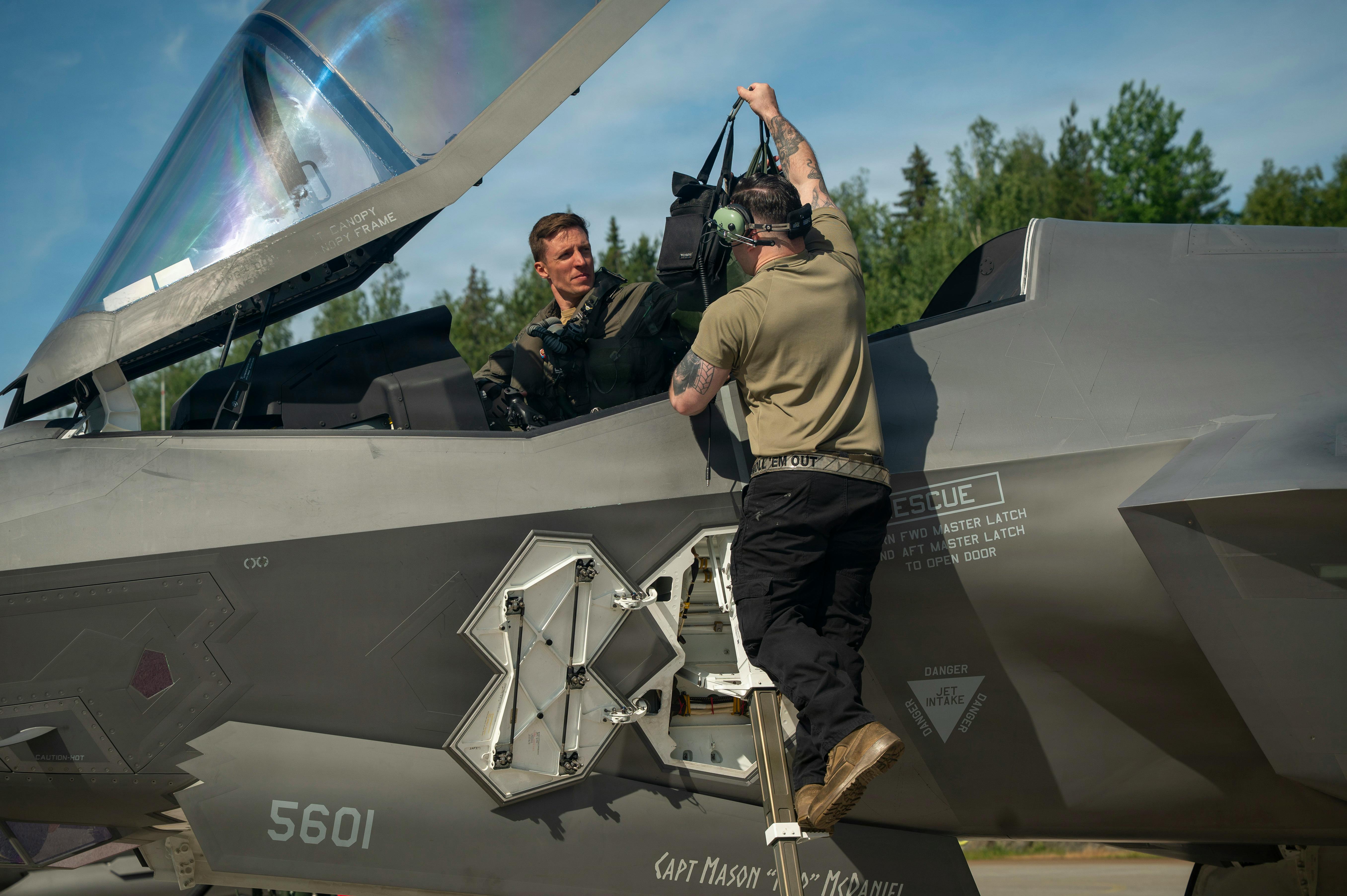 U.S. Air Force Staff Sgt. Christian Cornwell, 48th Equipment Maintenance Squadron, assists Capt. Logan Halverson, 493rd Fighter Squadron F-35A Lightning II pilot, during Ramstein Flag 26 at Pirkkala Air Base, Finland. U.S. Air Force photo by Tech. Sgt. Christine Groening.