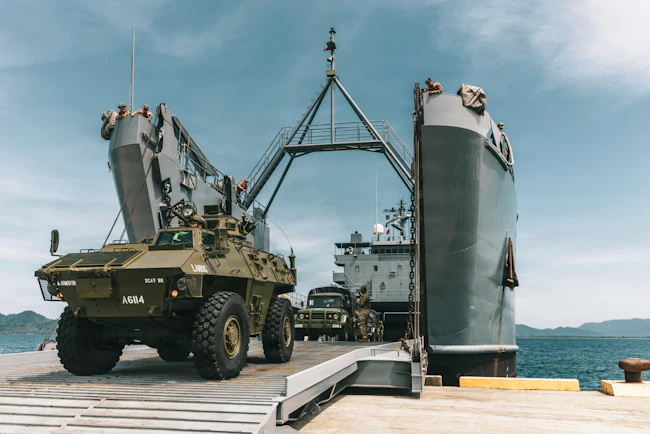 Philippine Army armored personnel carriers and trucks assigned to the 2nd Cavalry Battalion, Armored Division, offload from a U.S. Army Logistics Support Vessel as part of Exercise Salaknib 2026 at Casiguran, Philippines. U.S. Army photo by Pfc. Peter Bannister.
