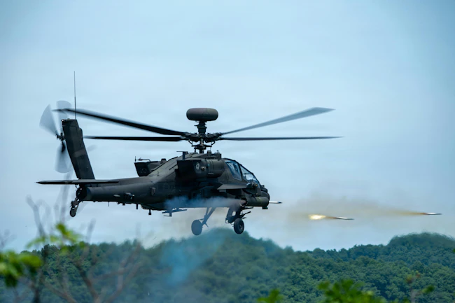 A U.S. Army AH-64 Apache assigned to 4th Battalion, 2nd Aviation Regiment, 2nd Combat Aviation Brigade, 2d Infantry Division/ROK-U.S. Combined Division fires during aerial gunnery at Rodriguez Live Fire Complex, South Korea. Aerial gunnery certifies AH-64 Apache aircrews on weapons employment and crew coordination during day and night conditions, ensuring mission-ready aviation forces across the Korean Peninsula. U.S. Army photo by Richard Kim.