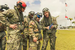 U.S. Navy Lt. Cmdr. Holmes, assistant regional engineer for Joint Region Marianas, briefs U.S. Army Lt. Gen. William J. Hartman, acting commander, U.S. Cyber Command, and U.S. Navy Rear Adm. Brett Mietus, commander, Joint Region Marianas, on key infrastructure sites prior to an aerial tour of Guam. The visit supported U.S. Cyber Command’s efforts to understand Guam’s physical infrastructure and its role in ensuring cybersecurity and defense resilience in the Indo-Pacific. U.S. Navy photo by William J. Busby III.