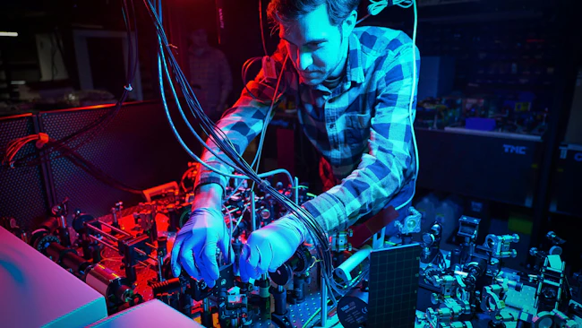 Air Force Research Laboratory scientists work across various technical platforms to accelerate quantum research and development of connected, ultra-secure quantum communication. A researcher at the AFRL Information Directorate is adjusting the Octave Spanning, 5 Femtosecond Ti:sapphire Laser in the Photonics Laboratory for optimal results. U.S. Air Force photo by Keith Lewis.