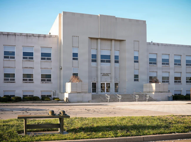 The sun rises over the Air Force Research Laboratory headquarters building at Wright-Patterson Air Force Base, Ohio. AFRL is the primary scientific research and development center for the Department of the Air Force, leading the discovery, development, and integration of warfighting technologies for air, space, and cyberspace forces. U.S. Air Force photo by Matthew Clouse.