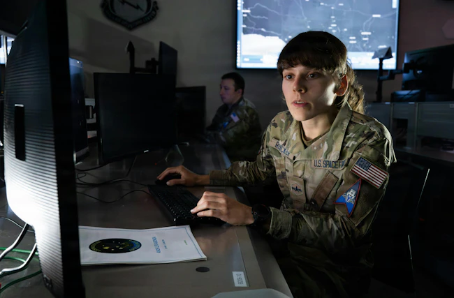A U.S. Space Force Guardian assigned to Combat Delta 1-5 monitors a space effects command and control display at the Combined Space Operations Center (CSpOC), Vandenberg Space Force Base, Calif. Members of Combat Delta 1-5 and the CSpOC maintain continuous watch to synchronize and deliver critical space-enabled effects to the Joint Force, ensuring operational command and control across global theaters. U.S. Space Force photo by David Dozoretz.