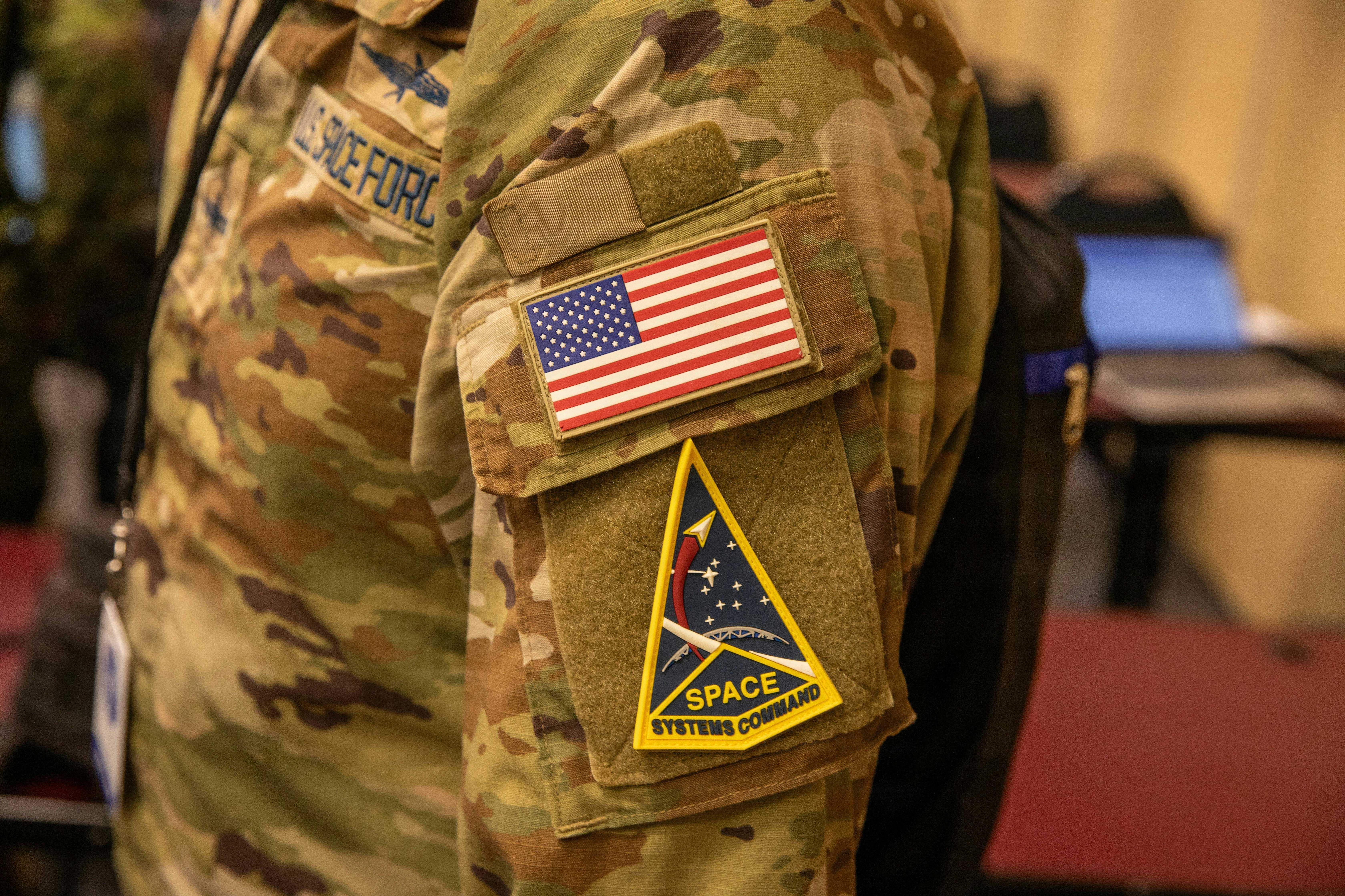 A U.S. Space Force Guardian poses for a photo displaying their unit patch during Cyber Shield 2026 at the Professional Education Center in Little Rock. Texas Army National Guard photo by Staff Sgt. Jason Archer.