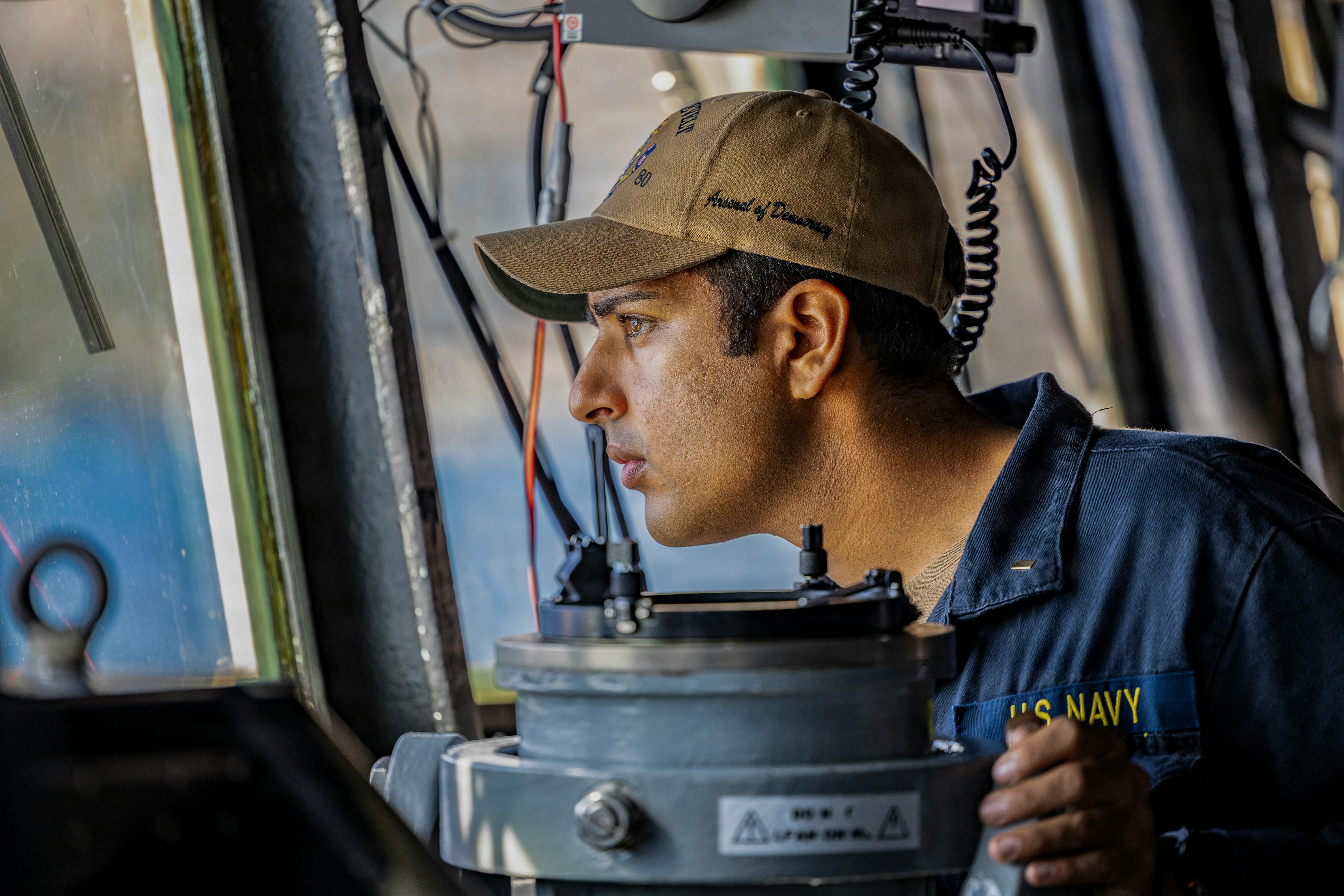 U.S. Navy Ensign Himmat Walha, electronic warfare officer assigned to the Arleigh Burke-class guided missile destroyer USS Roosevelt (DDG 80), checks the ship&rsquo;s heading. U.S. Navy photo by Mass Communication Specialist 1st Class Brandon Williams-Church.