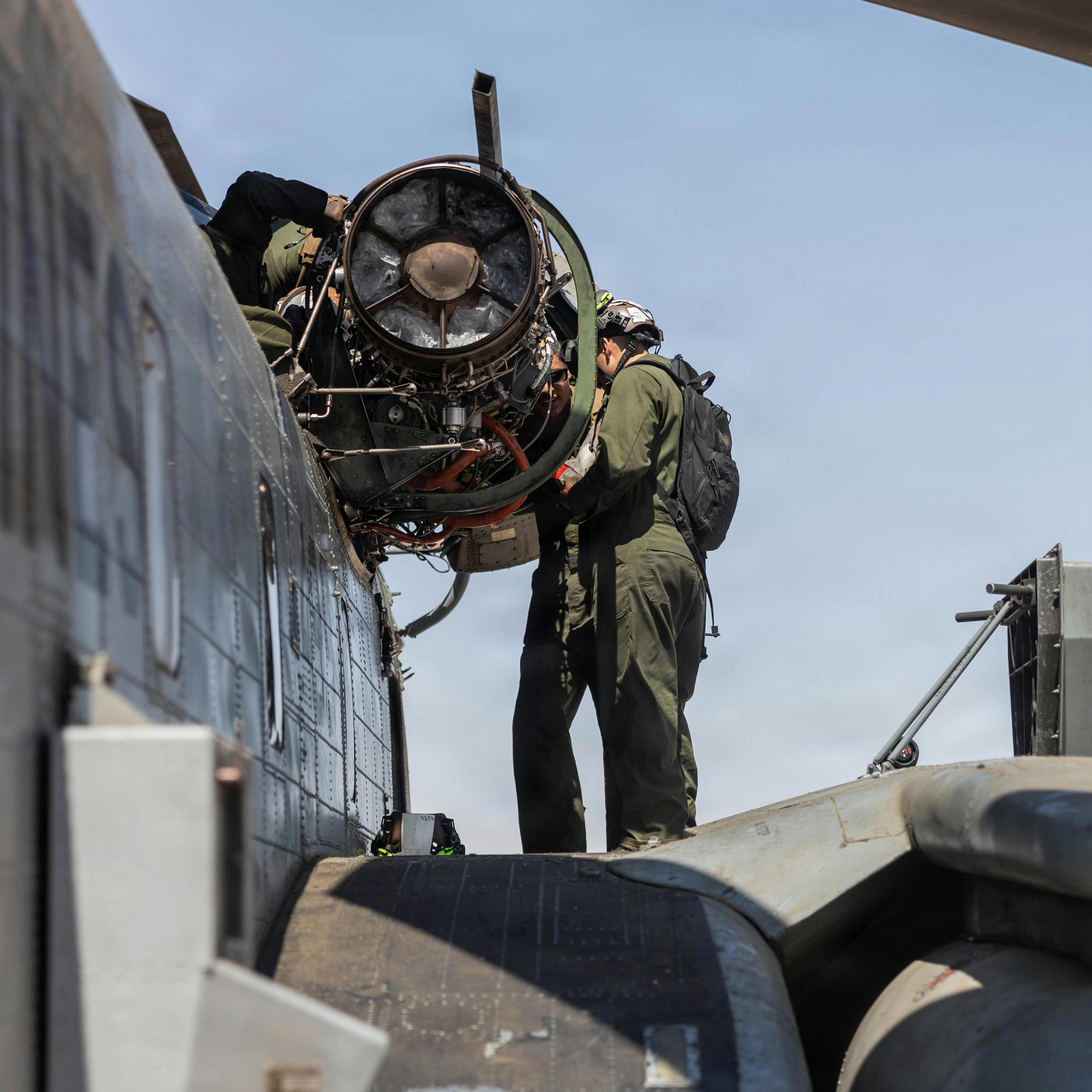 U.S. Marines with Heavy Marine Helicopter Squadron 462 (HMH-462), Marine Aircraft Group 16, 3rd Marine Aircraft Wing, conduct repairs on a CH-53 Super Stallion engine at the Strategic Expeditionary Landing Field, Marine Corps Air Ground Combat Center, Twentynine Palms, Calif. U.S. Marine Corps photo by Lance Cpl. Lainey Brummett.