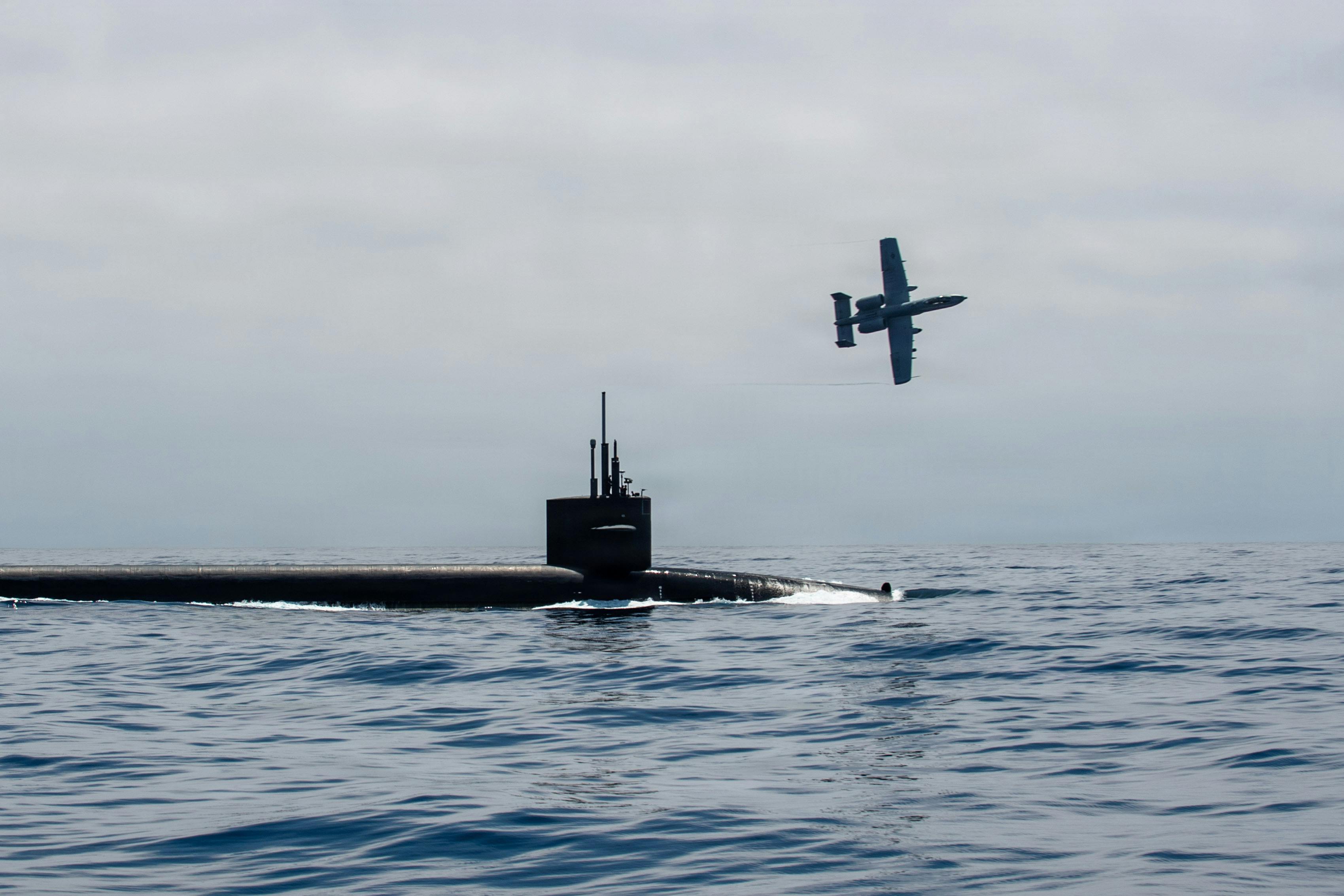 A U.S. Air Force A-10 Thunderbolt II aircraft escorts Ohio-class ballistic missile submarine USS Nebraska (SSBN 739) in the Pacific Ocean. U.S. Navy photo by Mass Communication Specialist 1st Class Ryan Riley.