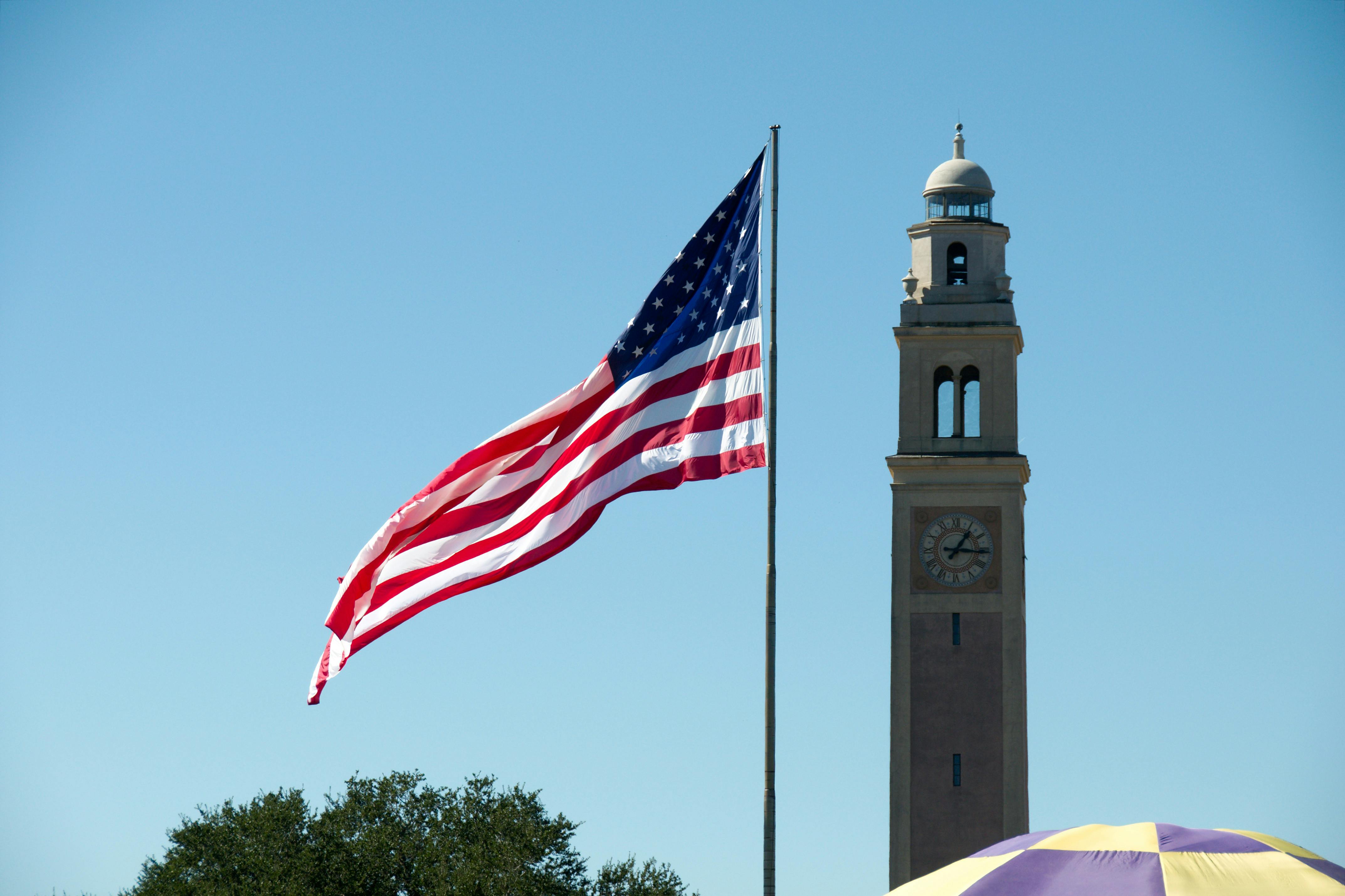 Flag of the United States at the Parade Ground at Louisiana State University, with the War Memorial Tower in the background. ID 148072136 &copy; Mfmegevand | Dreamstime.com