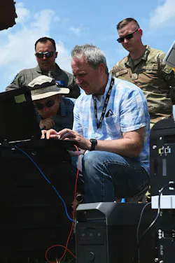Members of the Air Force and Ohio Air National Guard look at laptops during field prototype testing evaluation for the Collaborative Combat Aircraft (CCA) Portable Command and Control Enclave (C2E). U.S. Air National Guard photo by Shane Hughes.