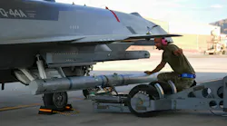 A U.S. Airman assigned to the Collaborative Combat Aircraft Experimental Operations Unit loads an inert missile onto a YFQ-44A Fury aircraft at Creech Air Force Base, Nev. USAF photo by Senior Airman Renee Blundon.