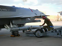 A U.S. Airman assigned to the Collaborative Combat Aircraft Experimental Operations Unit loads an inert missile onto a YFQ-44A Fury aircraft at Creech Air Force Base, Nev. USAF photo by Senior Airman Renee Blundon.