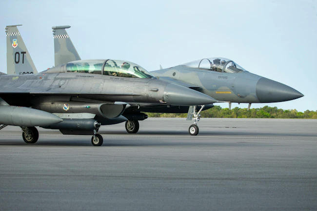 An F-16 and F-15 assigned to Eglin Air Force Base, Florida, prepare for a previous test of a datalink between two infrared search and track (IRST) pods. U.S. Air Force photo.