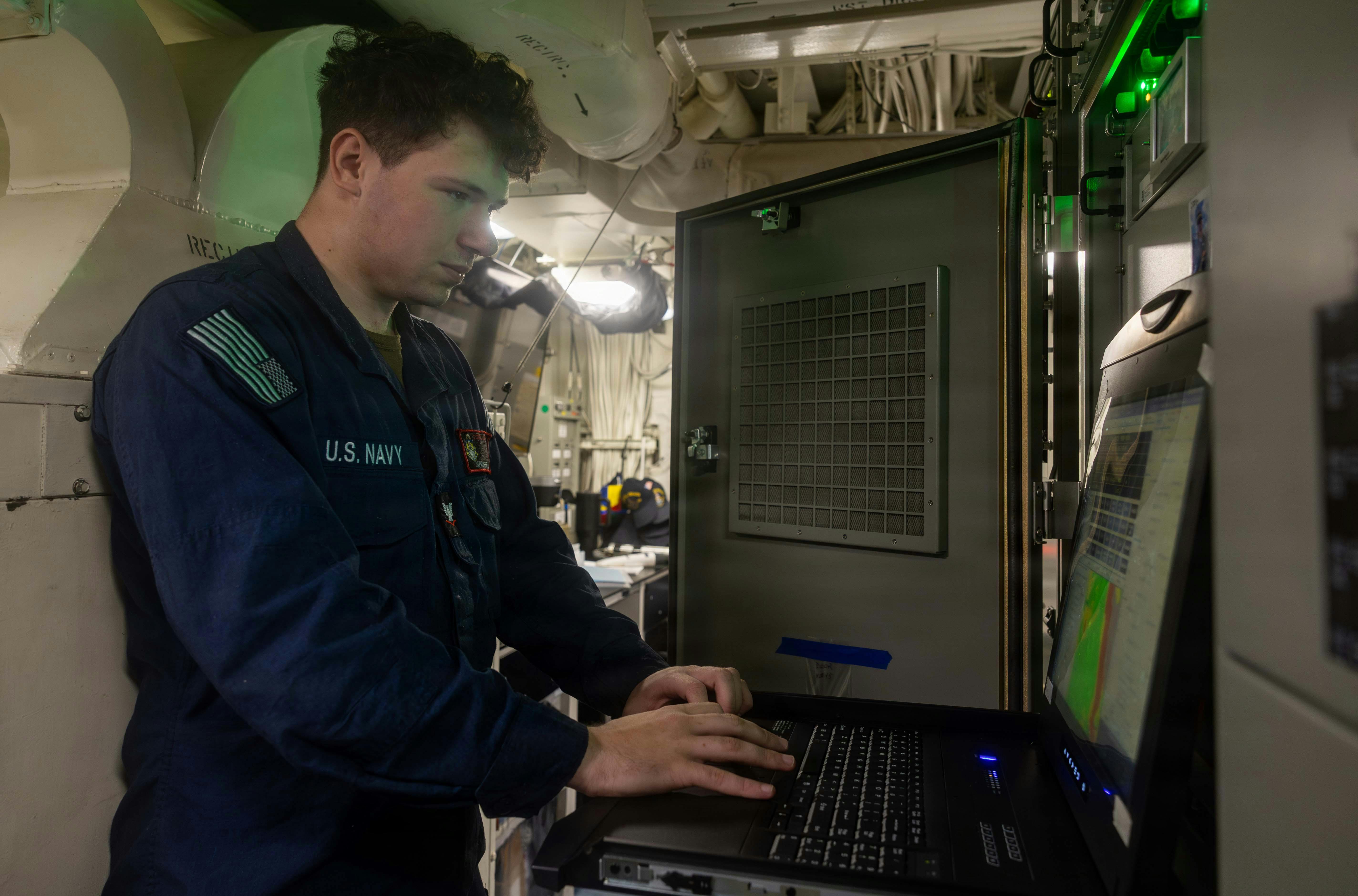 U.S. Navy Electronics Technician 3rd Class Fredrick Sprofera, from Missouri, monitors the WSN-7 inertial measuring unit of the GPS positioning navigation timing service aboard Arleigh Burke-class guided-missile destroyer USS Rafael Peralta (DDG 115) in the South China Sea. U.S. Navy photo by Mass Communication Specialist 1st Class Ryre Arciaga.