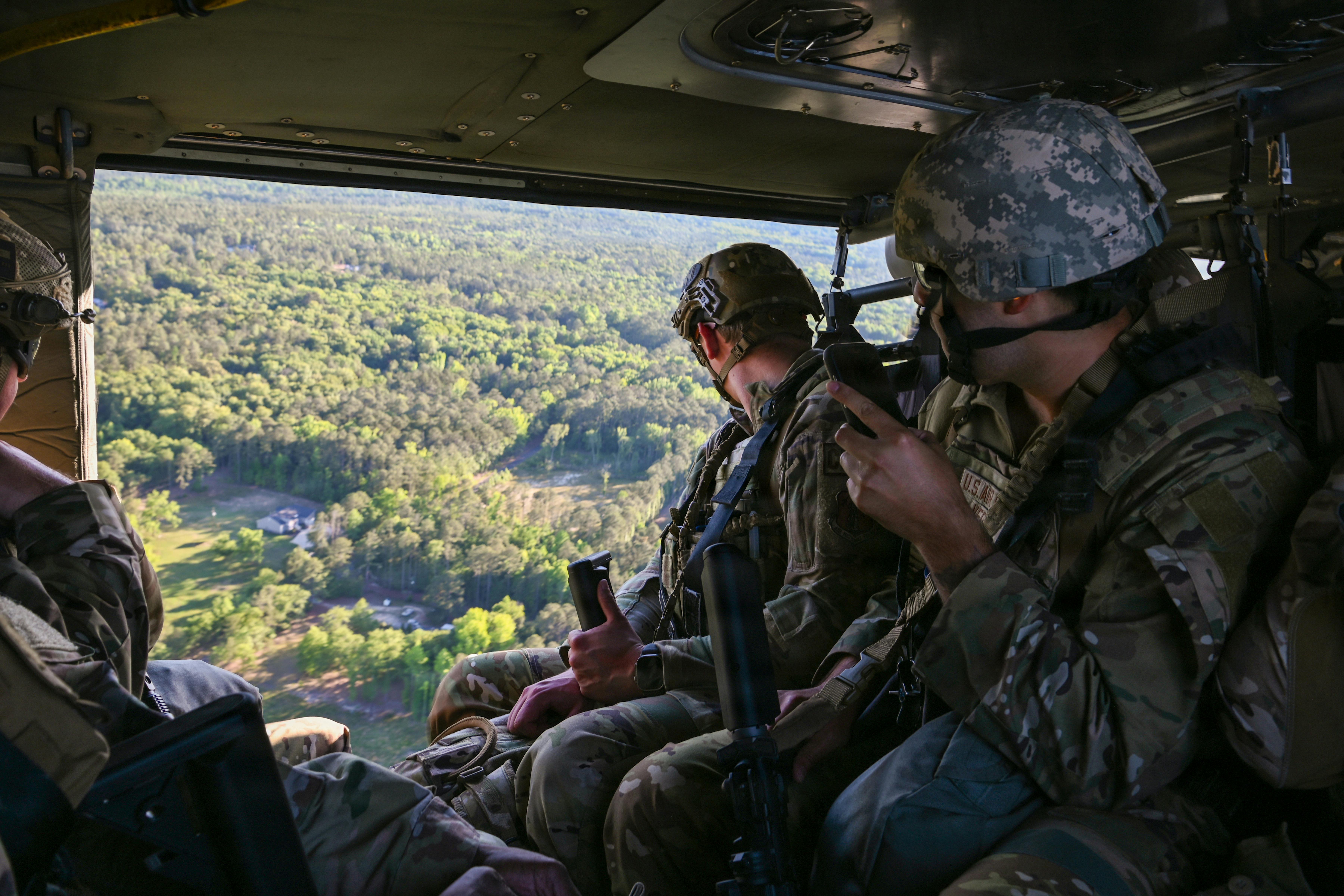 U.S. Airmen, assigned to multiple Air National Guard units, ride inside a U.S. Army UH-60 Black Hawk helicopter, assigned to the South Carolina National Guard, en route to McCrady Training Center, South Carolina, May 14, 2026, during emergency management battlefield expeditionary response training. U.S. Air National Guard photo by Senior Airman Julia Szoke.