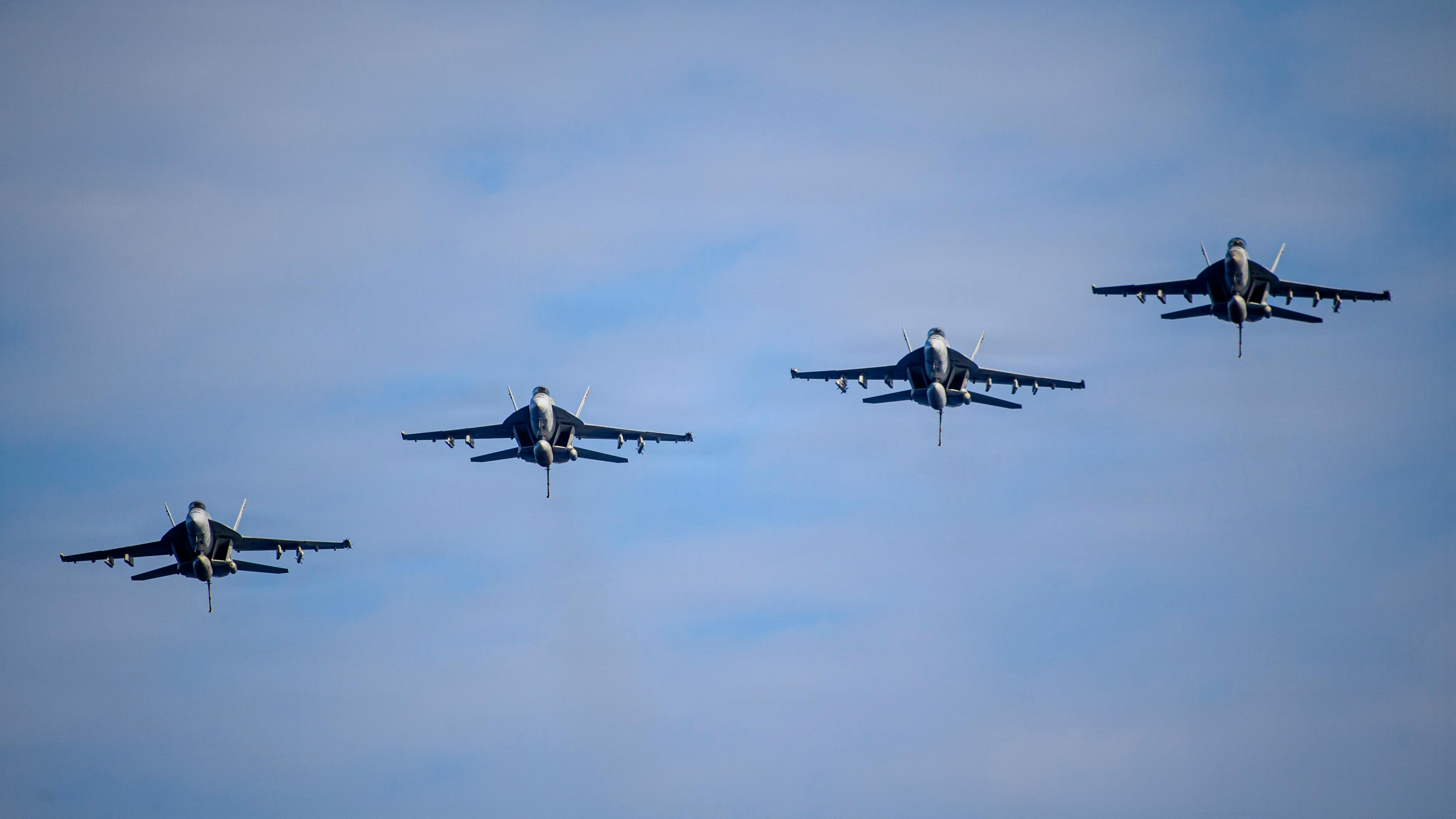 F/A-18E/F Super Hornets, attached to the 'Kestrels' of Strike Fighter Squadron (VFA) 137 prepare to land on the flight deck of Nimitz-class aircraft carrier USS Nimitz (CVN 68) following an air power demonstration. U.S. Navy photo.