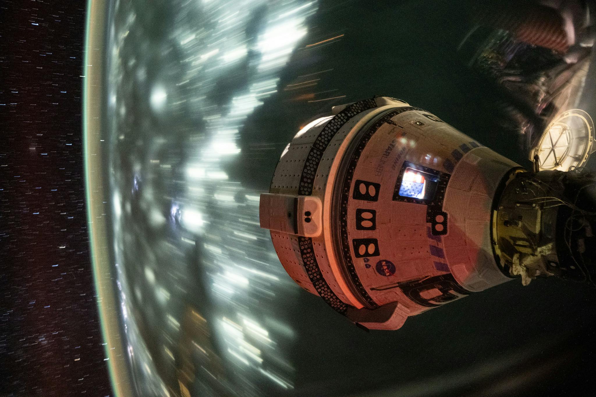 Boeing&rsquo;s Starliner spacecraft, which launched NASA&rsquo;s Crew Flight Test astronauts Butch Wilmore and Suni Williams to the International Space Station, is pictured docked to the Harmony module&rsquo;s forward port. This long-duration photograph was taken on July 3, 2024, from the orbital complex as it soared 256 miles above the Arabian Sea off the coast of Mumbai, India. NASA photo.