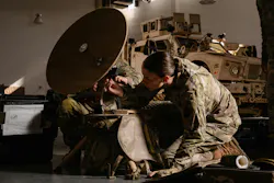U.S. Army 2nd Lt. Eleanor Simmons, a military intelligence officer with the 628th Intelligence and Electronic Warfare Battalion, connects wires to a Global Broadcast Service AN/TSR-11 in Laurel, Md. U.S. Army National Guard photo by Staff Sgt. Thomas Lamb and Sgt. Joshua Whitaker.