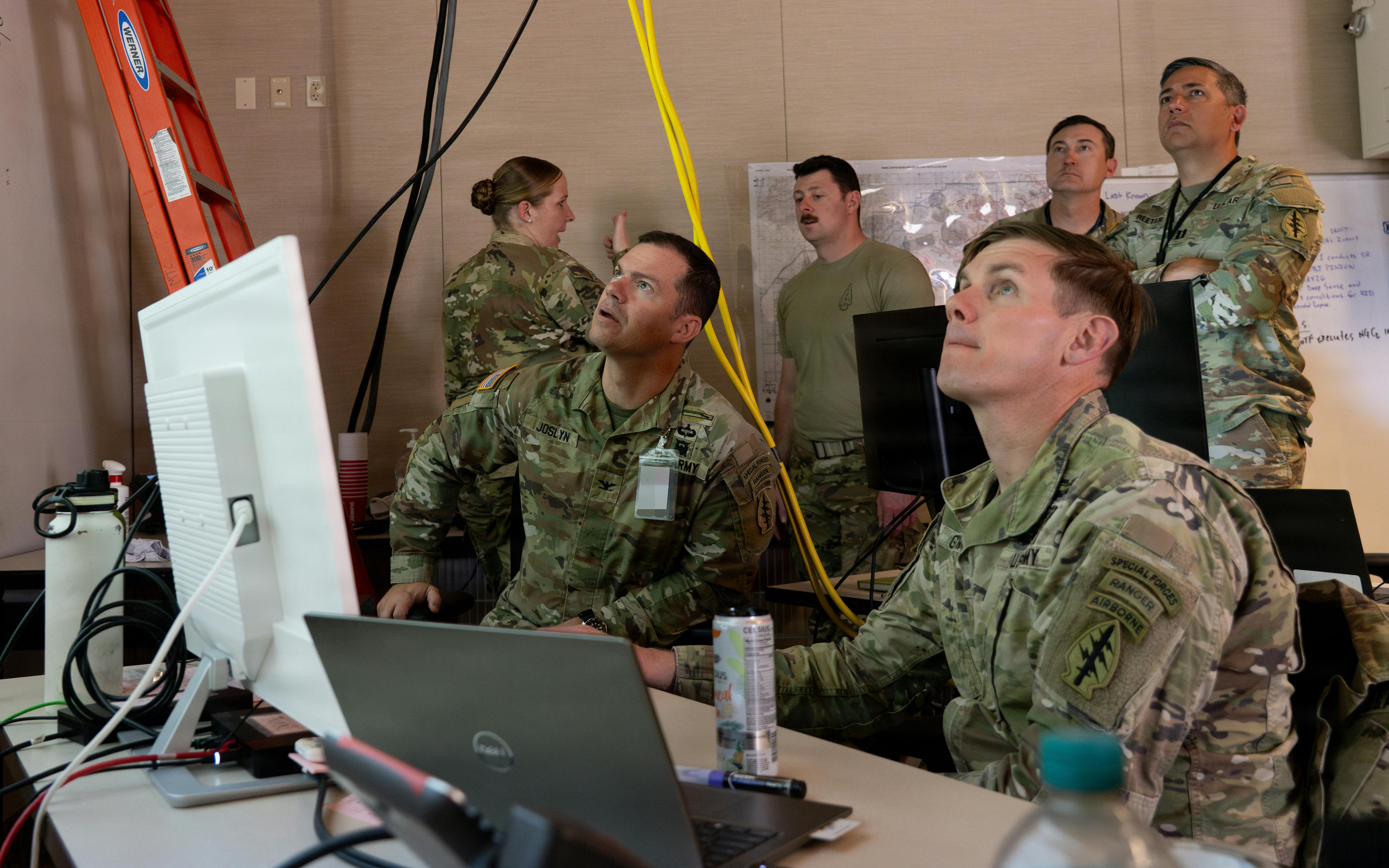 U.S. Army Col. Nathanael Joslyn, commander of the 10th Special Forces Group (Airborne), watches a presentation by Lt. Col. Zachary Griffiths, commander of 4th Battalion, 10th Special Forces group (Airborne), at the Mission Training Center, Fort Carson, Colo. Col. Joslyn was briefed on tactical command operations and the integration of Next Generation Command and Control (NGC2). U.S. Army photo by Sgt. Casey Dinnison.