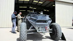 Chief Warrant Officer 2 Zackary Cowher, Cyber Capabilities Developer Technician for Multi-Domain Command - Europe, uploads configuration files to an autonomous land-based vehicle equipped with a tethered UAS quadcopter during Arcane Thunder 26 at Fort Irwin, Calif. U.S. Army photo.
