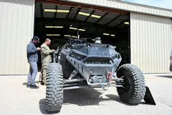 Chief Warrant Officer 2 Zackary Cowher, Cyber Capabilities Developer Technician for Multi-Domain Command - Europe, uploads configuration files to an autonomous land-based vehicle equipped with a tethered UAS quadcopter during Arcane Thunder 26 at Fort Irwin, Calif. U.S. Army photo.