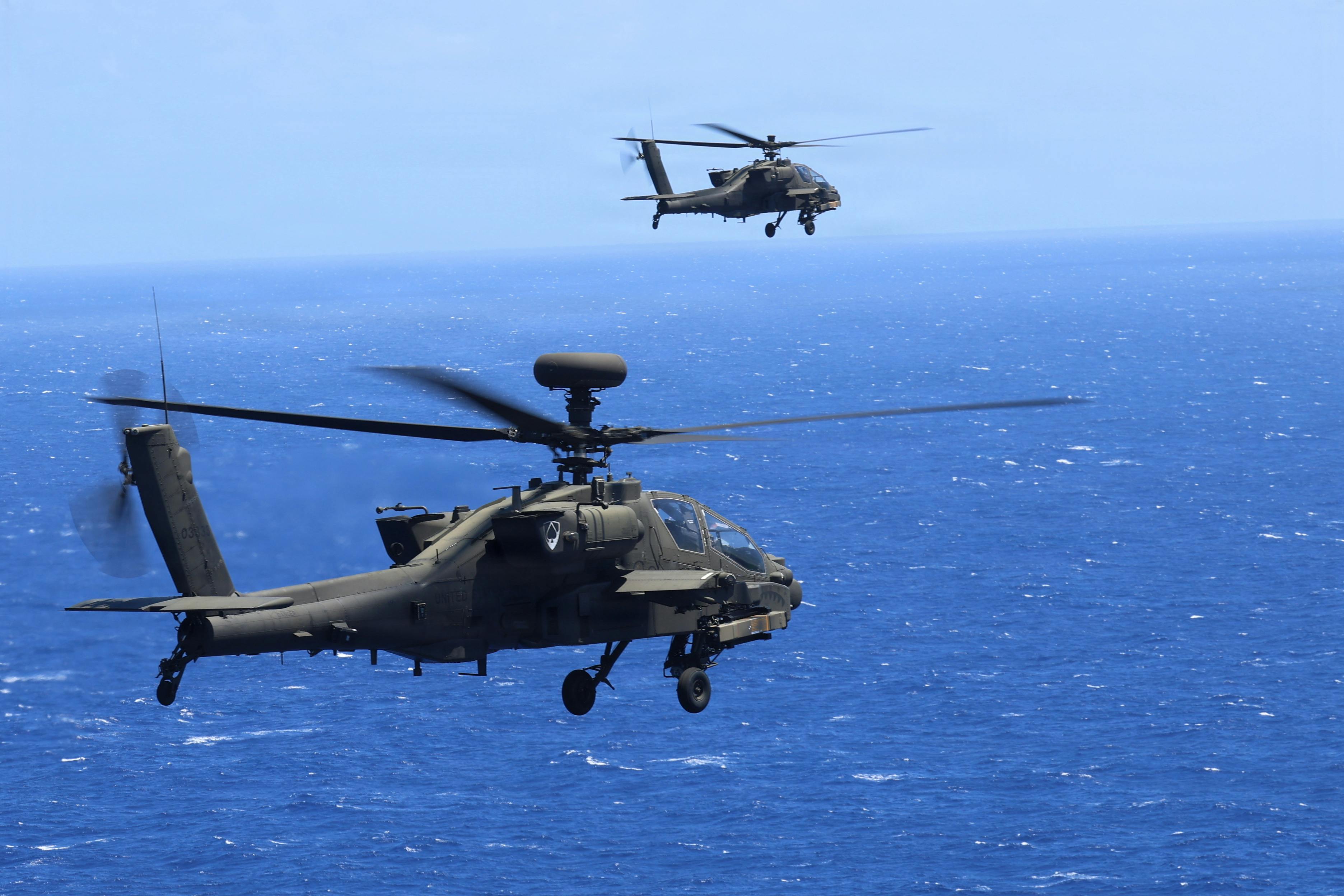 Two U.S. Army AH-64 Apaches from the 16th Combat Aviation Brigade, 7th Infantry Division (Multi-Domain Command - Pacific) fire spike missiles during a sinking exercise as part of Exercise Rim of the Pacific 2026. U.S. Army photo by Staff Sgt. Christian Morton.
